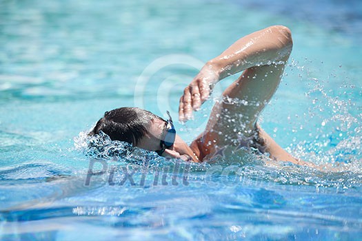 Young man swimming the front crawl in a pool Young man swimming the front crawl in a pool