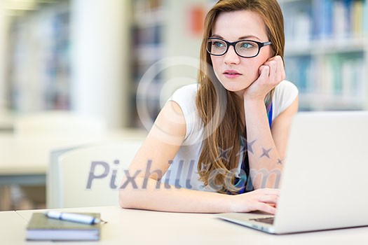 Pretty, female college student in a library, looking for a book (shallow DOF; color toned image) Pretty, female college student in a library, looking for a book (shallow DOF; color toned image)