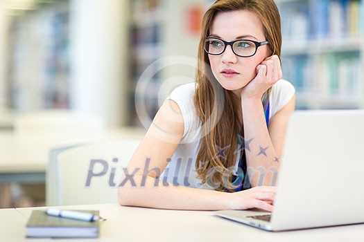 Pretty, female college student in a library, looking for a book (shallow DOF; color toned image)