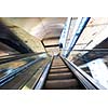 Shopping mall center escalators. Zoom blur movement.