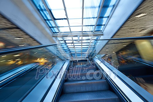Shopping mall center escalators. Zoom blur movement.