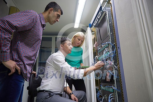 business people group, network engeneers working in network server room on tablet computer