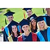 young graduates students group  standing in front of university building on graduation day