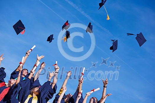 high school students graduates tossing up hats over blue sky. high school students graduates tossing up hats over blue sky.