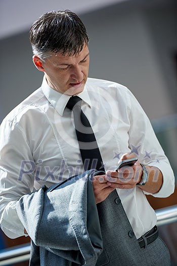business man using phone at modern office space business man using phone at modern office space