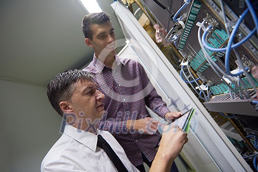 business people group working on tablet computer, network engineers in server room business people group working on tablet computer, network engineers in server room