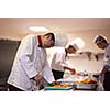 chef in hotel kitchen preparing and decorating food, delicious vegetables and meat  meal dinner