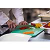 chef in hotel kitchen  slice  vegetables with knife and prepare food