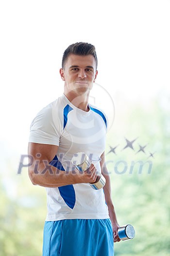 young man in fintess sport club exercise with weights and relaxing