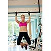 healthy lifestile, young woman in fitness gym lifting on bar and working on her back and hands muscles