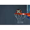 Basketball ball,  board and net  on grey  background in gym indoor