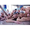 happy teen  group  at swimming pool class  learning to swim and have fun