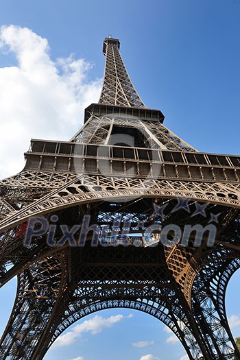 Eiffel Tower in Paris against a dramatic blue sky at day tourist and travel attraction