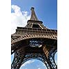 Eiffel Tower in Paris against a dramatic blue sky at day tourist and travel attraction