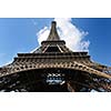 Eiffel Tower in Paris against a dramatic blue sky at day tourist and travel attraction