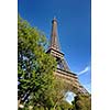 Eiffel Tower in Paris against a dramatic blue sky at day tourist and travel attraction