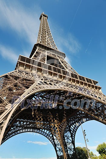 Eiffel Tower in Paris against a dramatic blue sky at day tourist and travel attraction