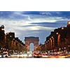 Beautiful night view with car traffic and rush at eavning of the Arc de Triomphe, Paris, France.