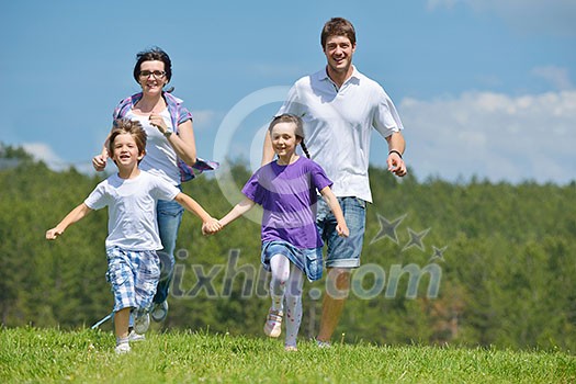 happy young family with their kids have fun and relax outdoors in nature with blue sky in background