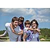 happy young family with their kids have fun and relax outdoors in nature with blue sky in background