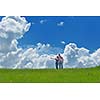 Portrait of romantic young couple in love  smiling together outdoor in nature with blue sky in background