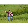 Portrait of romantic young couple in love  smiling together outdoor in nature with blue sky in background