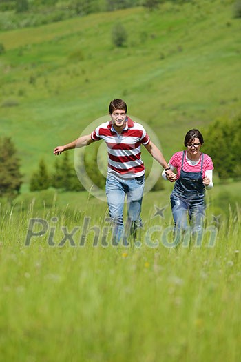 Portrait of romantic young couple in love smiling together outdoor in nature with blue sky in background Portrait of romantic young couple in love smiling together outdoor in nature with blue sky in background