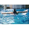 Happy muscular swimming woman  wearing glasses and cap at swim pool and represent health and fit concept