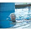 beautiful old senior  woman have fun and recreation on swimming pool 