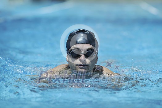 young healthy with muscular body man swim on swimming pool and representing healthy and recreation concept young healthy with muscular body man swim on swimming pool and representing healthy and recreation concept