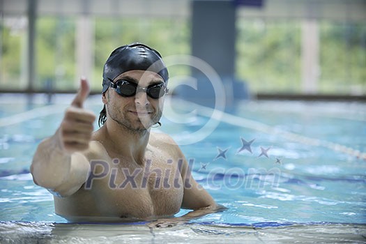 young healthy with muscular body man swim on swimming pool and representing healthy and recreation concept young healthy with muscular body man swim on swimming pool and representing healthy and recreation concept