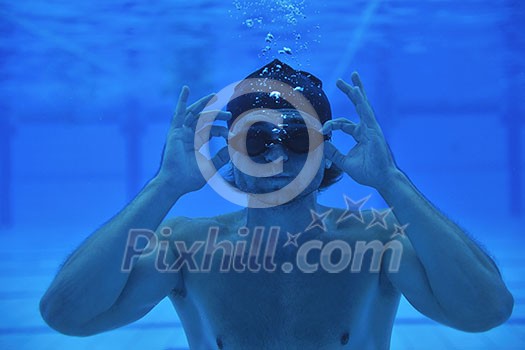 undervater shoot of swimming pool with good looking young swimmer undervater shoot of swimming pool with good looking young swimmer