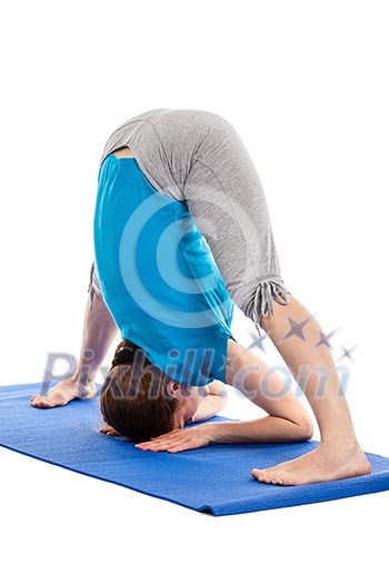 Yoga - young beautiful slender woman yoga instructor doing Wide Legged standing Forward Bend A (Prasarita Padottanasana A) asana exercise isolated on white background Yoga - young beautiful slender woman yoga instructor doing Wide Legged standing Forward Bend A (Prasarita Padottanasana A) asana exercise isolated on white background