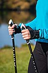 Nordic walking exercise adventure hiking concept - closeup of woman's hand holding nordic walking poles