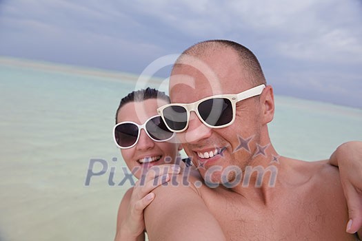 happy young couple have fun and relax at summer vacation on background maldives travel location and beautiful white sand beach happy young couple have fun and relax at summer vacation on background maldives travel location and beautiful white sand beach