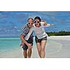 happy young couple have fun and relax at summer vacation on background maldives travel location and beautiful white sand beach