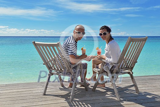 happy young couple relax and take fresh drink at summer vacation happy young couple relax and take fresh drink at summer vacation