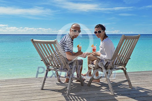 happy young couple relax and take fresh drink at summer vacation