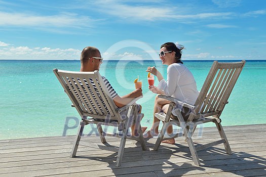 happy young couple relax and take fresh drink at summer vacation