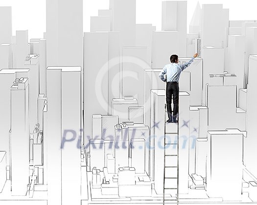 Rear view of businessman standing on ladder and drawing project Rear view of businessman standing on ladder and drawing project