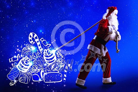 Santa Clause and Christmas gifts against blue background