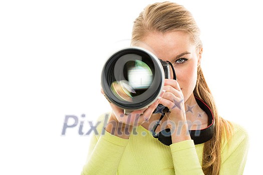 Pretty, female photographer with digital camera  - DSLR and a huge telephoto lens (color toned image; shallow DOF)