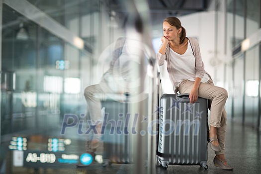 Young female passenger at the airport, about to check-in