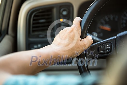 Driver's hands on the steering wheel
