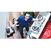 young dj man with headphones and compact disc dj equipment on party event