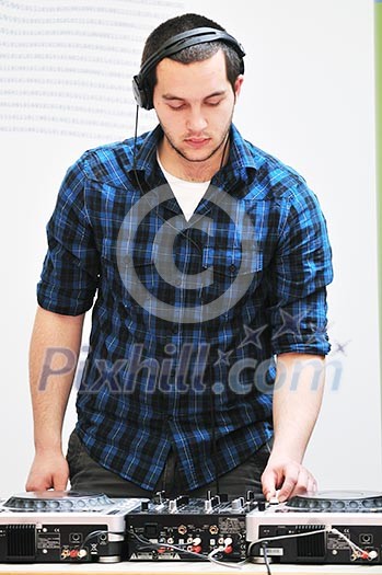 young dj man with headphones and compact disc dj equipment on party