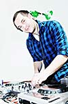 young dj man with headphones and compact disc dj equipment on party