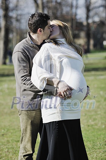 happy young married family couple outdoor in nature have fun and waiting baby and representing young family growth and pregnancy concept happy young married family couple outdoor in nature have fun and waiting baby and representing young family growth and pregnancy concept