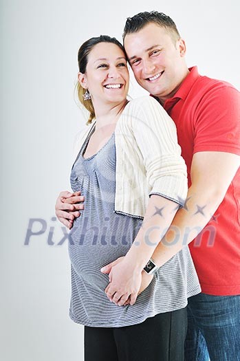 young family couple together in studio isolated on white. happy and waiting for baby young family couple together in studio isolated on white. happy and waiting for baby