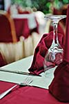 restaurant table with empty wine glass and red table decoration